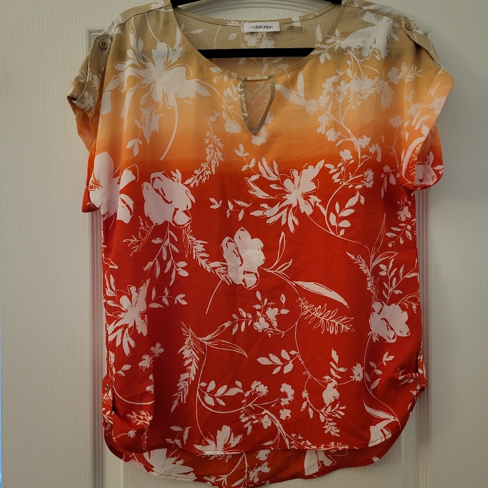 Tan/ orange/ red medium Calvin Klein short sleeve blouse.